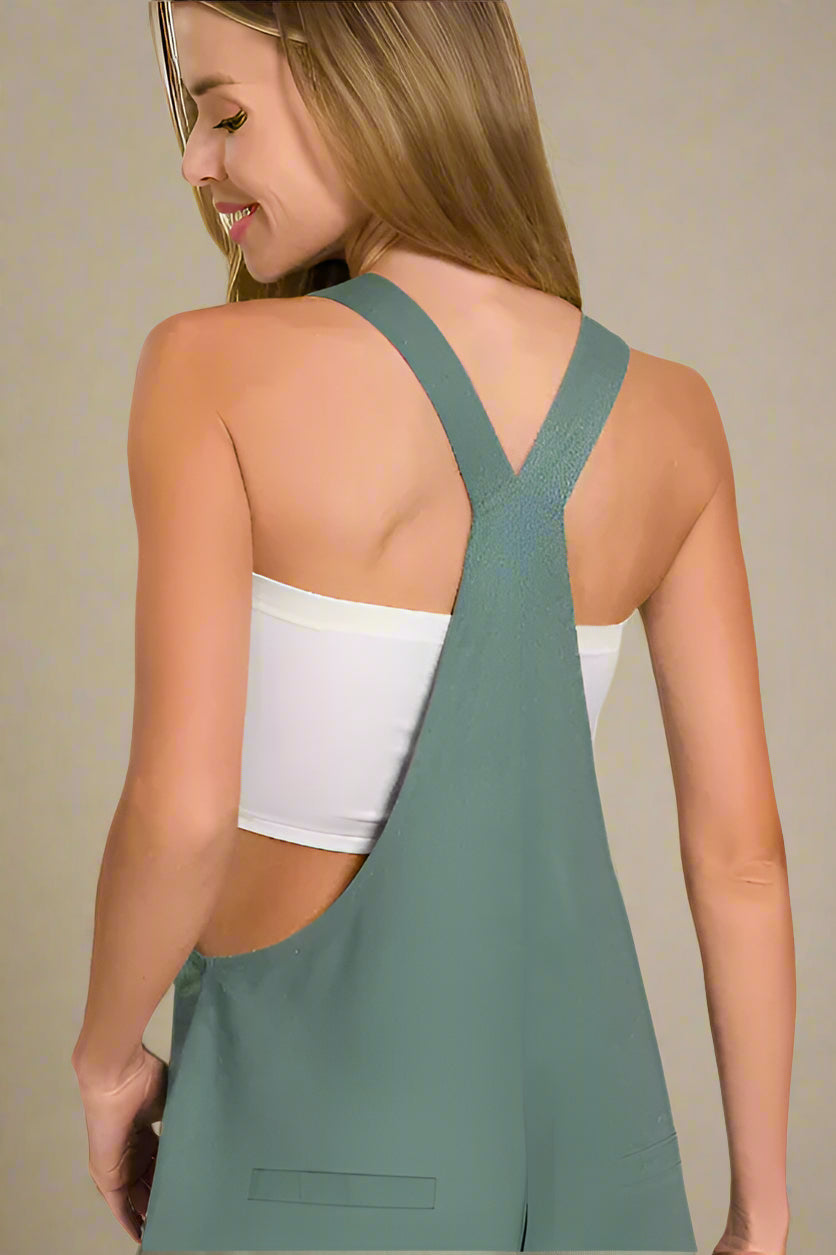 Model wearing Woven Knot Strap Overalls in green with a stylish back design and crop top