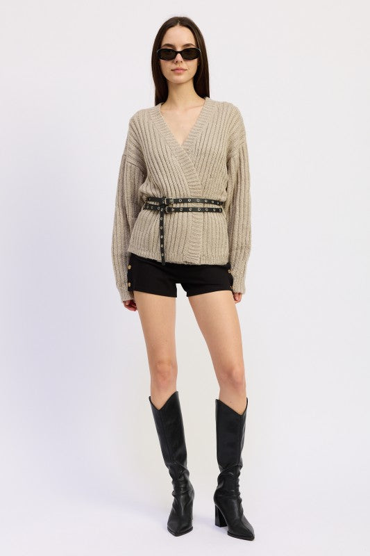 Emory Park Wrapped Cardigan With Belt in beige, styled with shorts and knee-high boots for a chic look.